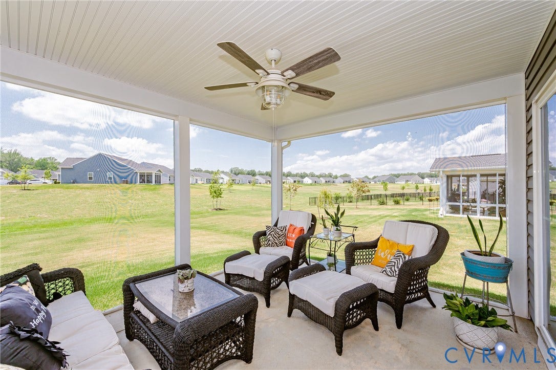 7627 E Danube Loop, New Kent, VA 23124 Spacious screened porch featuring a ceiling fan, concrete flooring, and an open-air feel