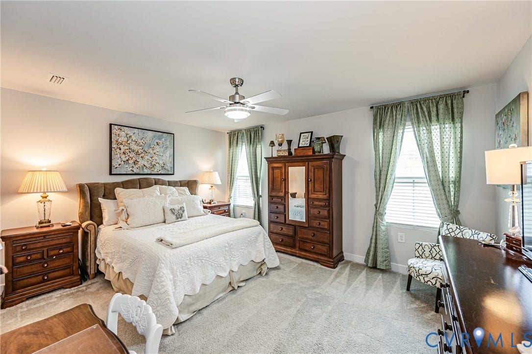 7627 E Danube Loop, New Kent, VA 23124 Spacious room featuring light gray walls, textured carpeting, and a ceiling fan with integrated lighting