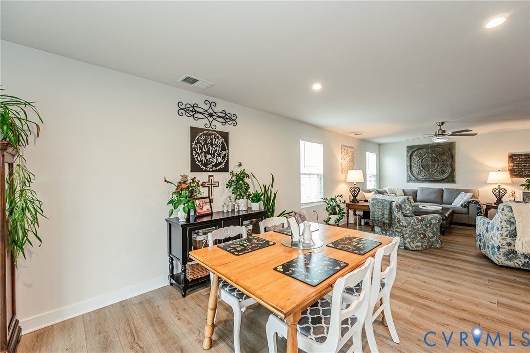 7627 E Danube Loop, New Kent, VA 23124 Open-concept living area with wood-finish flooring, recessed lighting, and white baseboards