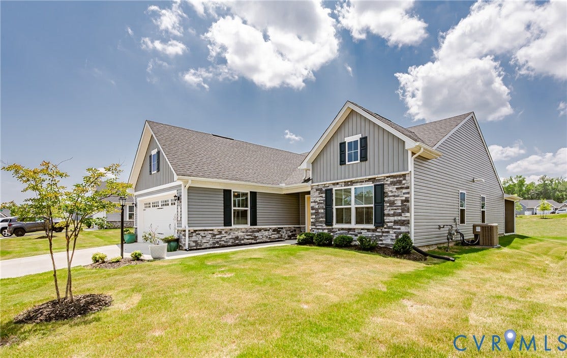 7627 E Danube Loop, New Kent, VA 23124 Contemporary exterior featuring light gray siding with stone veneer accents