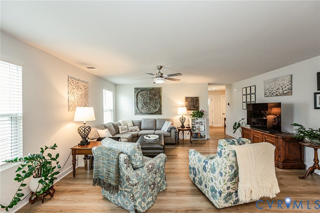 7627 E Danube Loop, New Kent, VA 23124 Spacious living area featuring wood-finish flooring, light-colored walls, recessed lighting, and ceiling fan