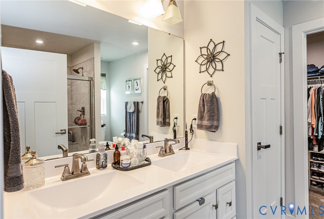 7627 E Danube Loop, New Kent, VA 23124 Double vanity with integrated sinks and brushed nickel faucets set in a white countertop