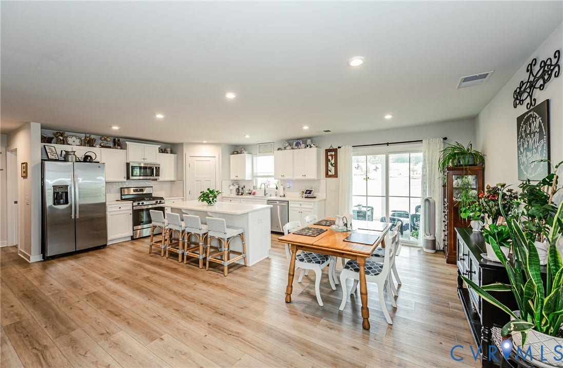 7627 E Danube Loop, New Kent, VA 23124 Spacious kitchen and dining area featuring light wood-finish flooring