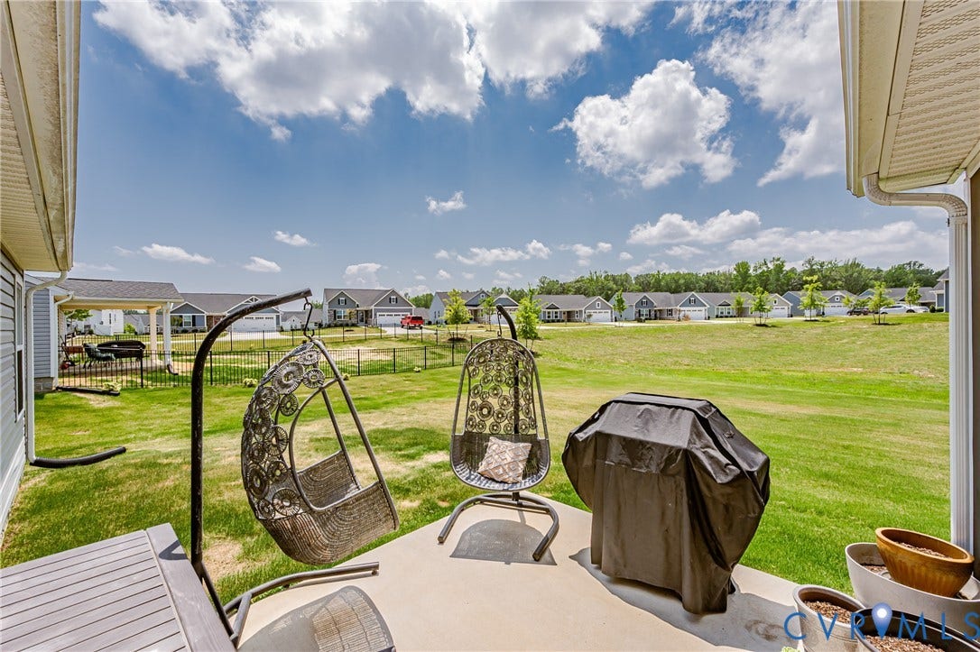 7627 E Danube Loop, New Kent, VA 23124 Concrete patio featuring an expansive grass area beyond