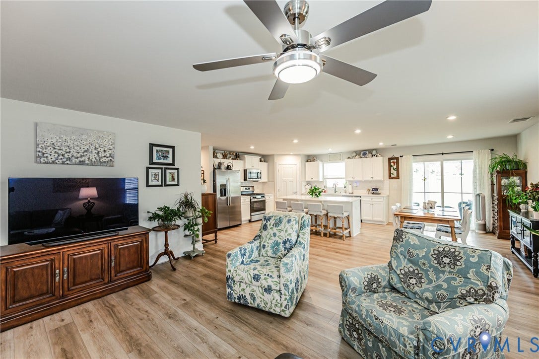 7627 E Danube Loop, New Kent, VA 23124 Open-concept living space featuring wood-finish flooring, recessed lighting, and a contemporary ceiling fan with integrated light