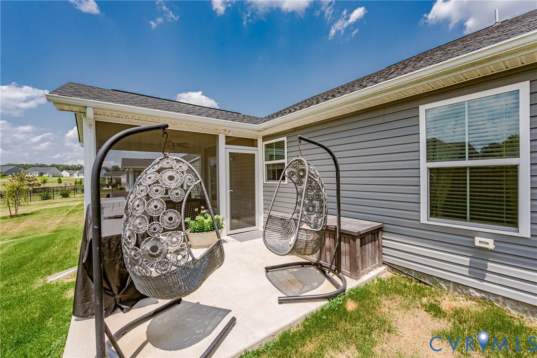 7627 E Danube Loop, New Kent, VA 23124 Rear concrete patio with a screened porch entry