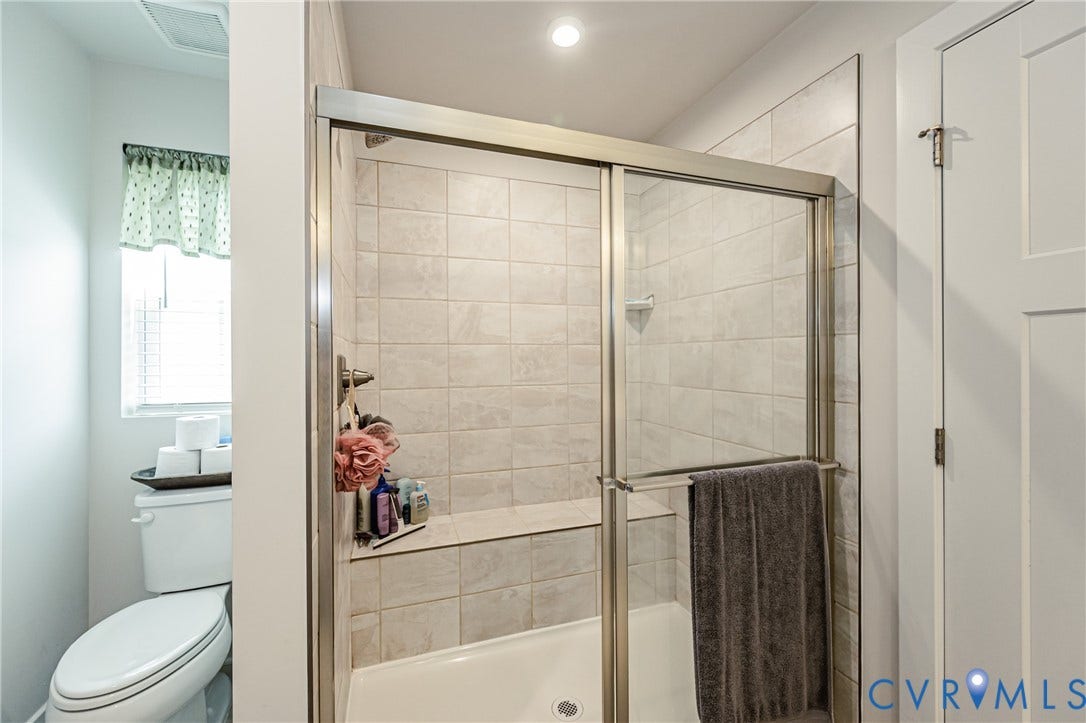 7627 E Danube Loop, New Kent, VA 23124 Shower with glass enclosure, tile surround, and built-in bench seating