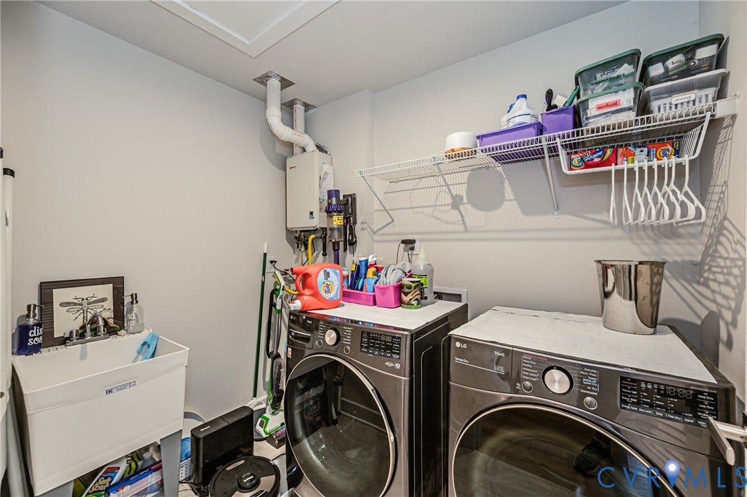7627 E Danube Loop, New Kent, VA 23124 Dedicated laundry area featuring a utility sink, wall-mounted water heater, and a white wire shelving system