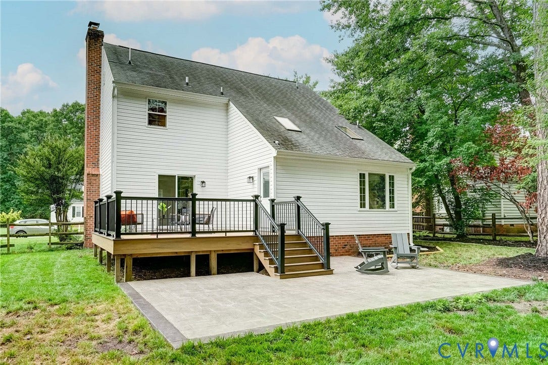 9724 Kingscroft Drive, Kingston, Glen Allen, VA 23060 Rear exterior featuring white siding, a multi-level deck with black railings and steps, and an expansive paver patio