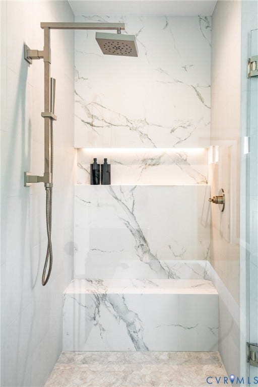 4507 Leonard Parkway, Richmond, VA 23221 Shower stall featuring a rain showerhead, handheld shower, built-in niche with accent lighting, integrated bench, and a clear glass enclosure