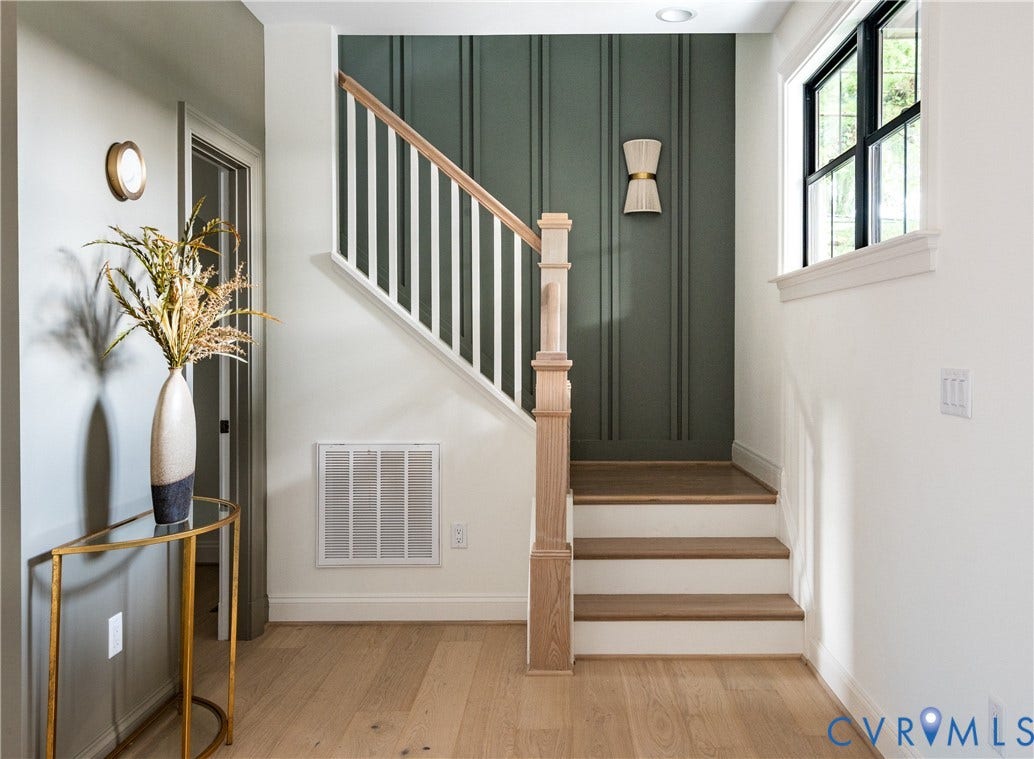 4507 Leonard Parkway, Richmond, VA 23221 Staircase with natural wood handrail and newel post, white balusters, and wood-finish treads