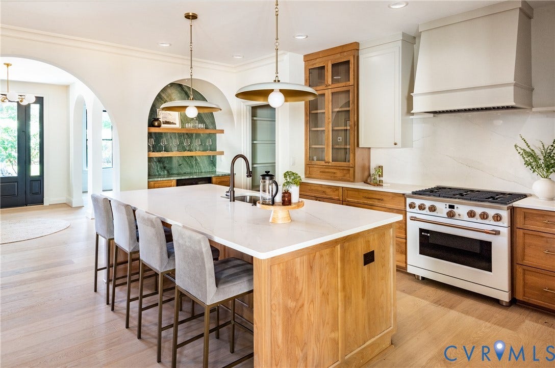 4507 Leonard Parkway, Richmond, VA 23221 Gourmet kitchen featuring a substantial island with seating, a professional-grade range, custom cabinetry, a built-in beverage center, and light wood-finish flooring