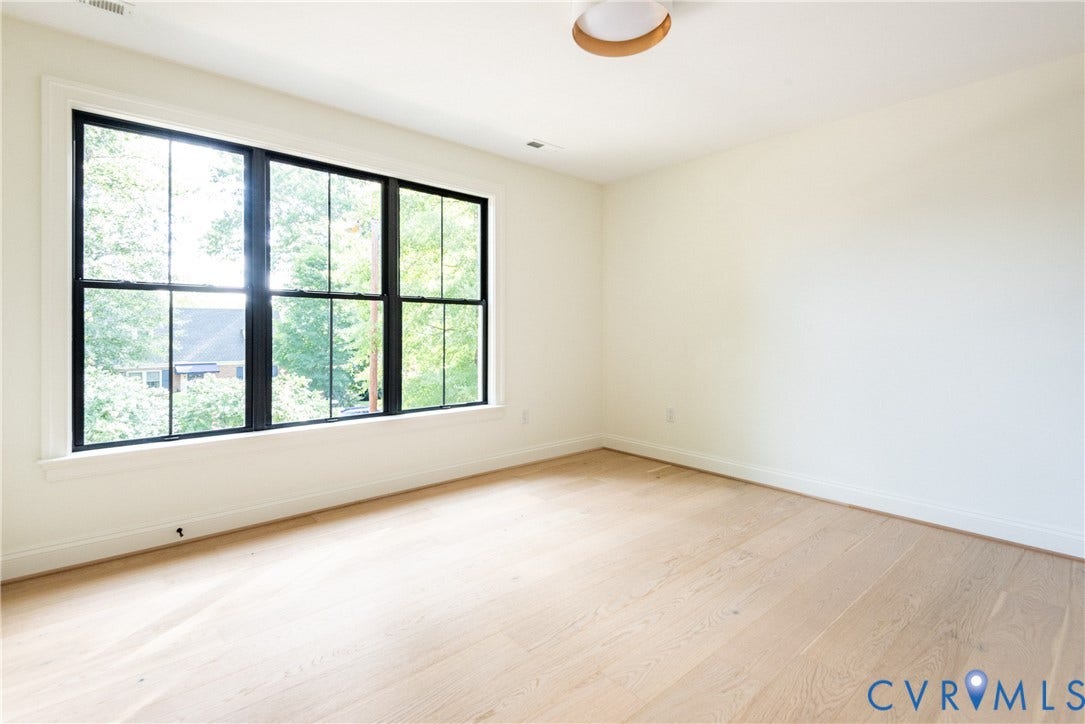 4507 Leonard Parkway, Richmond, VA 23221 Room featuring a large window with black framing, white trim, and light wood-finish flooring