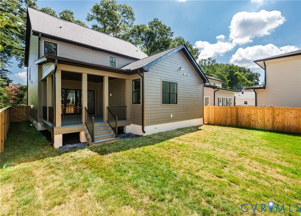 4507 Leonard Parkway, Richmond, VA 23221 Rear exterior featuring a covered porch, wood plank flooring, dark railing, and a private yard