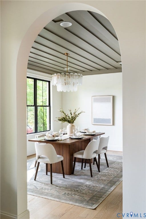 4507 Leonard Parkway, Richmond, VA 23221 Arched entryway leading to a dining space featuring a coffered ceiling and a multi-tiered chandelier