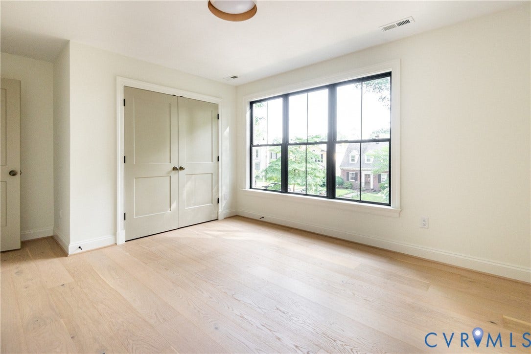 4507 Leonard Parkway, Richmond, VA 23221 Bright room featuring light wood-finish flooring, a large multi-pane window with black trim, and a double-door closet
