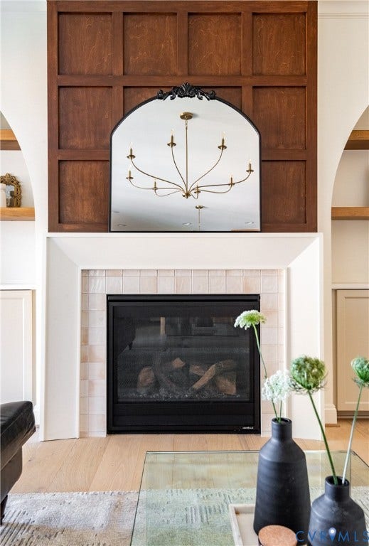 4507 Leonard Parkway, Richmond, VA 23221 Fireplace featuring a tiled surround, a white mantel, and a dark wood-paneled wall above