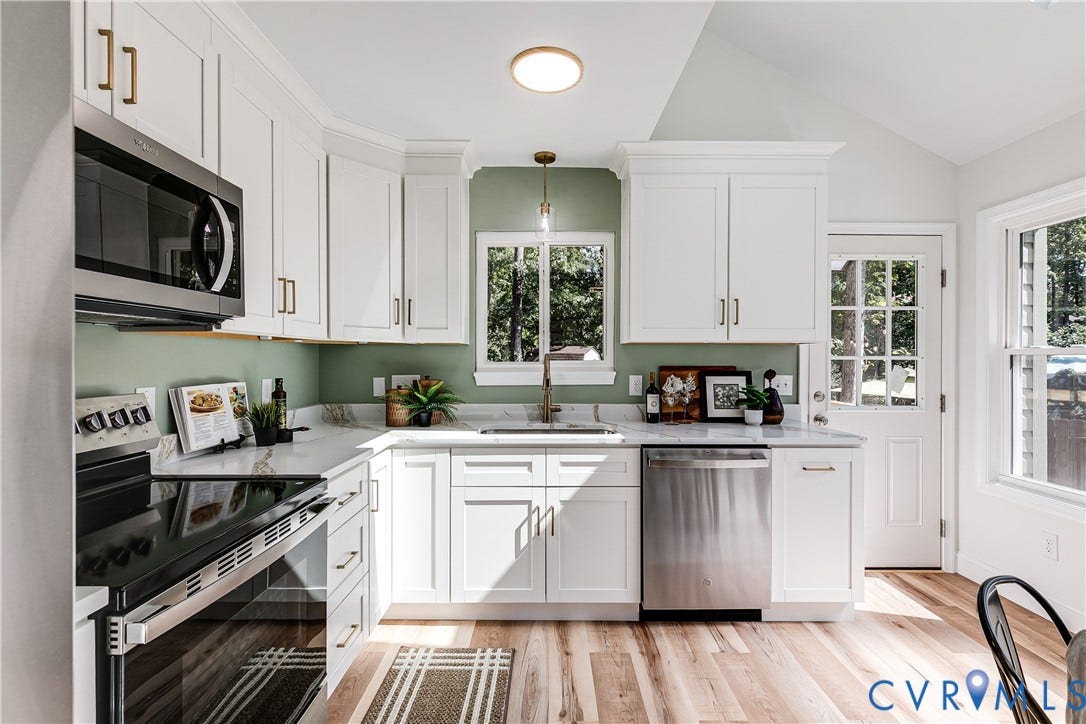 Newly renovated kitchen with quartz countertops, stainless steel appliances, and recessed lighting