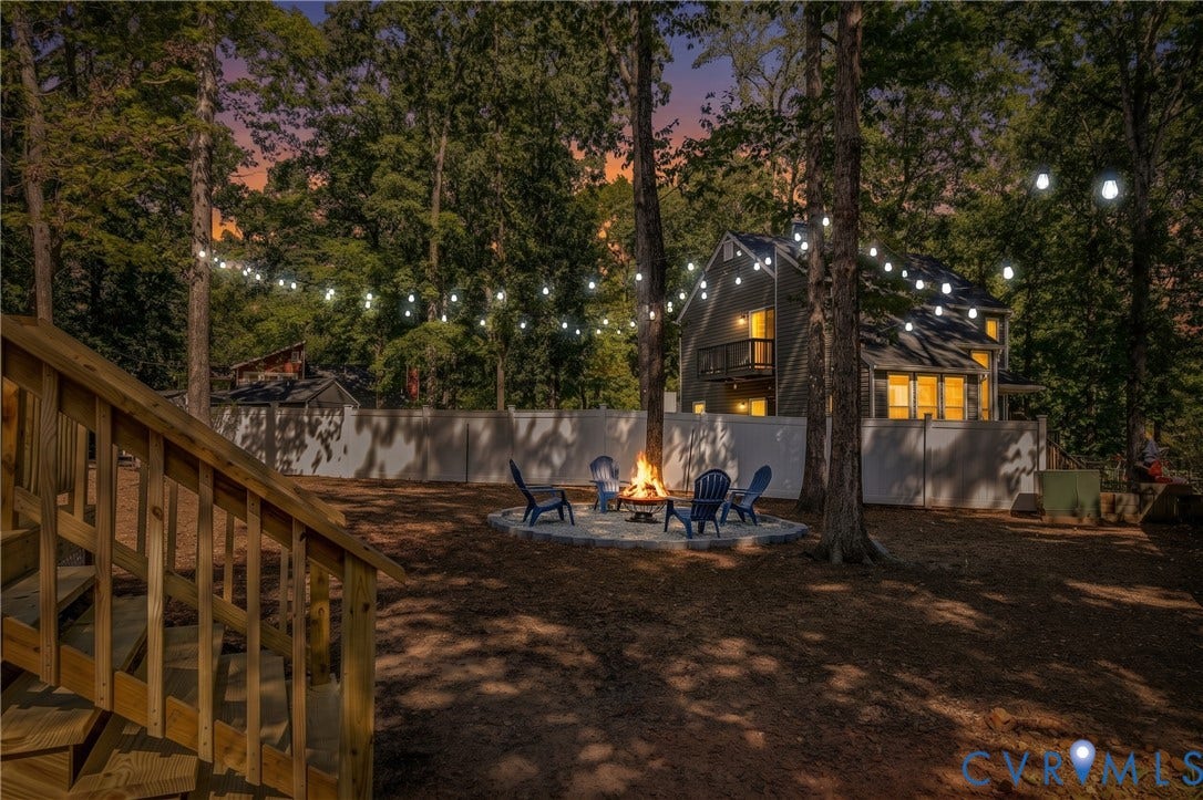 A peaceful evening setting surrounded by mature trees and soft outdoor lighting