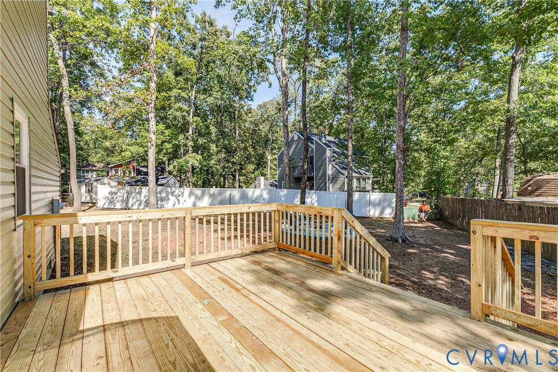 Spacious new wooden deck extends the home's living space into the backyard