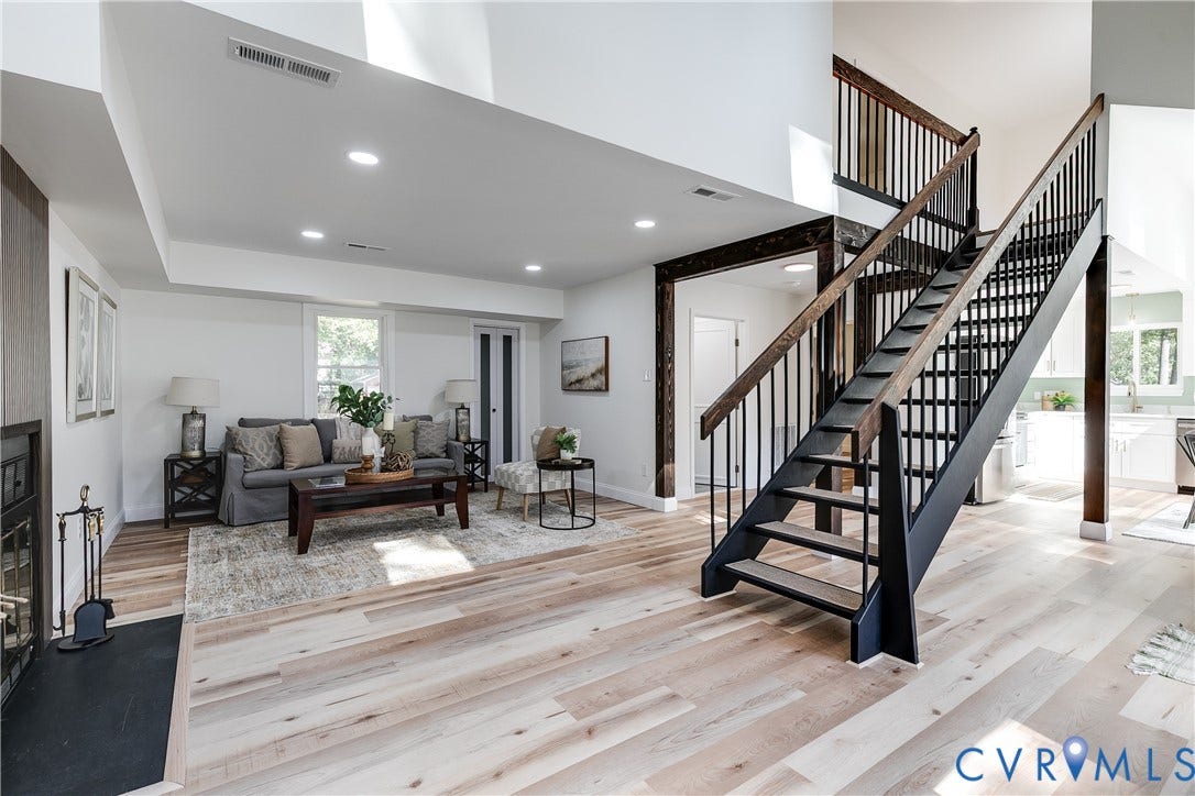 Bright open living room with vaulted ceilings and new LVP flooring (2026)
