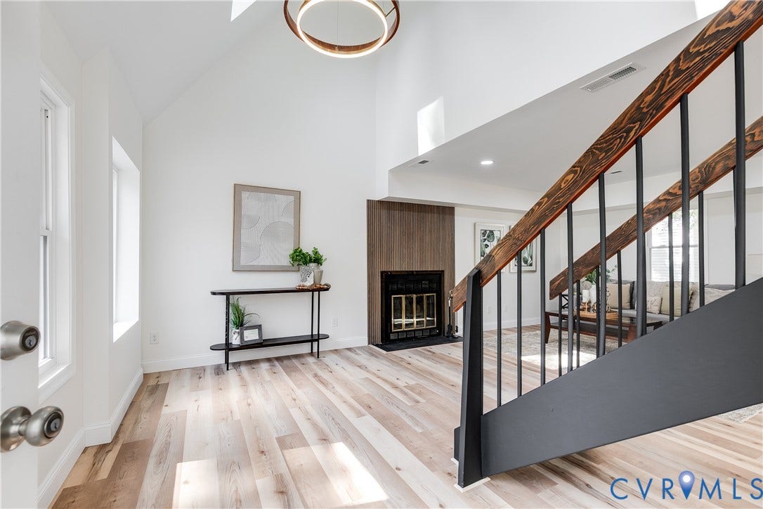 Comfortable living space with soaring ceilings and a wood-burning fireplace