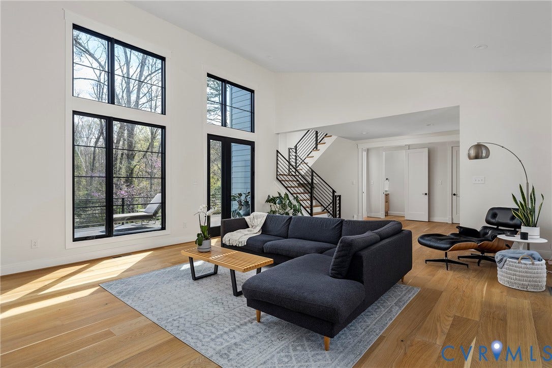 7301 Riverside Drive, Richmond, VA 23225 Two-story living area with tall, black-framed windows and a double-height ceiling