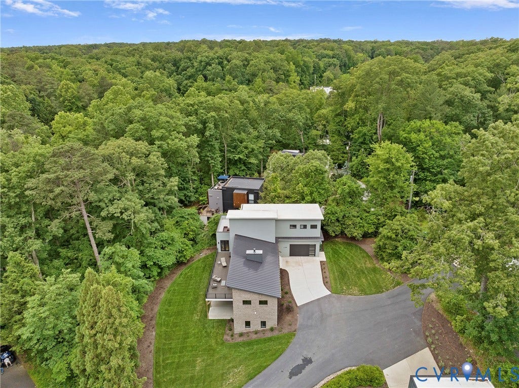7301 Riverside Drive, Richmond, VA 23225 Contemporary architecture featuring multiple levels, a dark gray roof, and a light gray and stone exterior