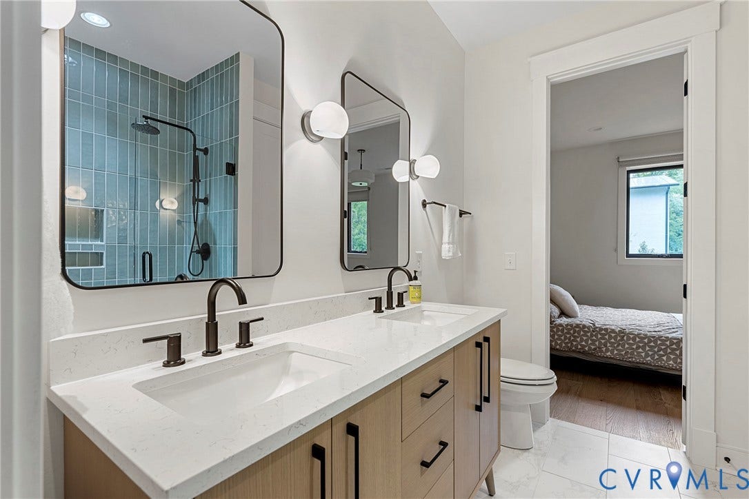 7301 Riverside Drive, Richmond, VA 23225 Modern bathroom featuring a dual vanity with light wood-finish cabinetry, white stone countertops, and matte black fixtures
