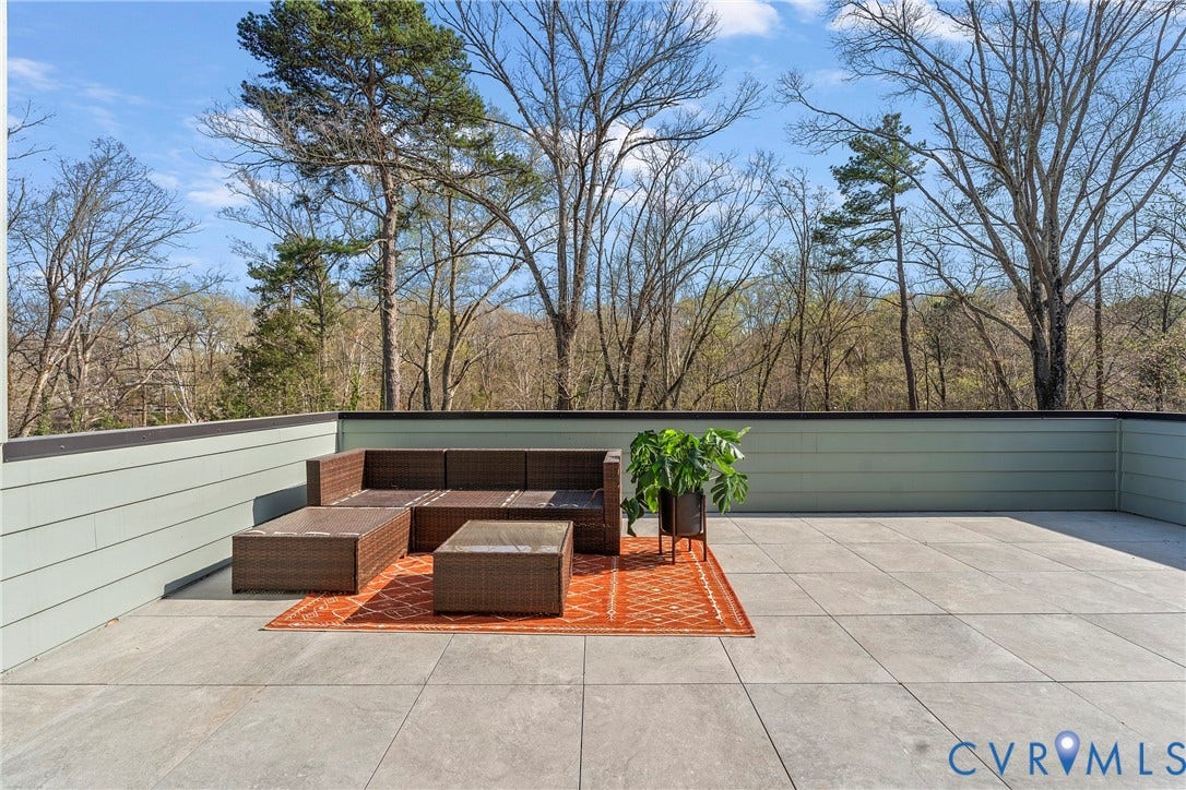 7301 Riverside Drive, Richmond, VA 23225 Expansive outdoor patio featuring large format tile flooring and a perimeter wall with horizontal siding
