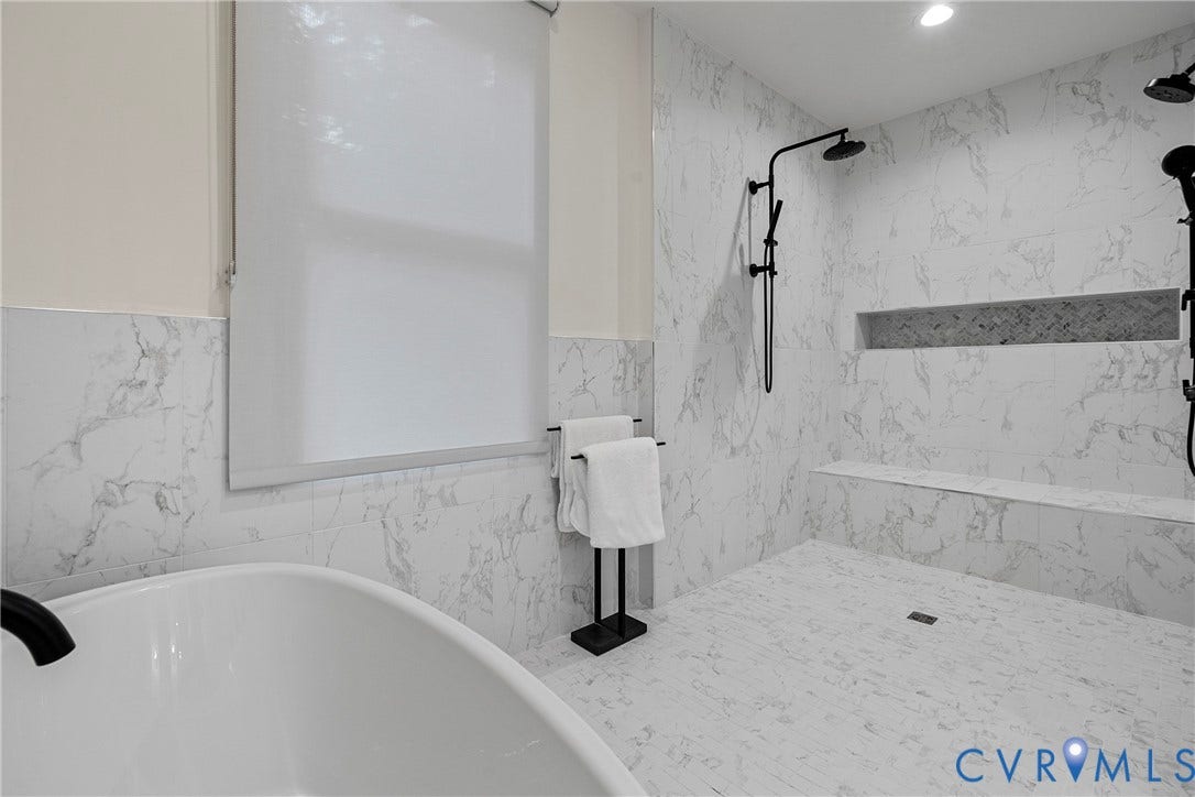 7301 Riverside Drive, Richmond, VA 23225 Freestanding soaking tub complemented by a spacious shower featuring a built-in bench and dual shower heads