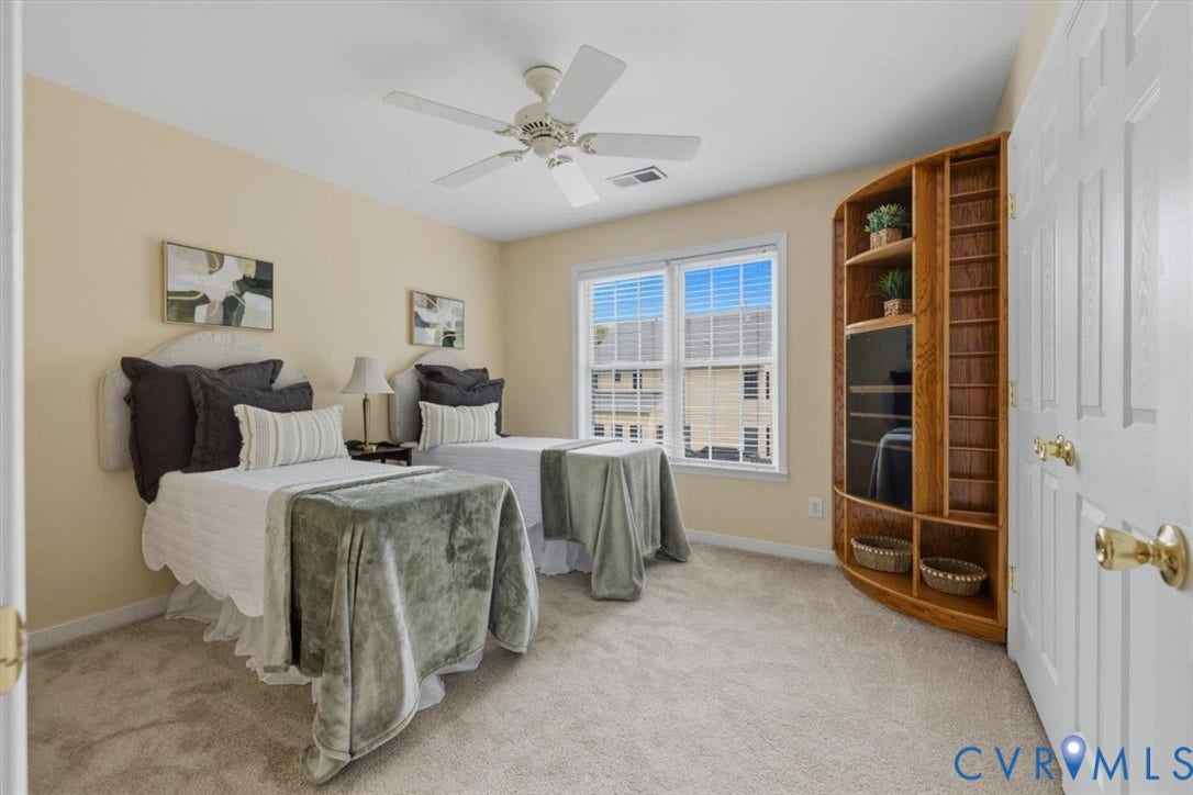 1824 Sidney Court, Glen Allen, VA 23059 Carpeted room featuring a ceiling fan, a double window with blinds, and a built-in wooden shelving unit