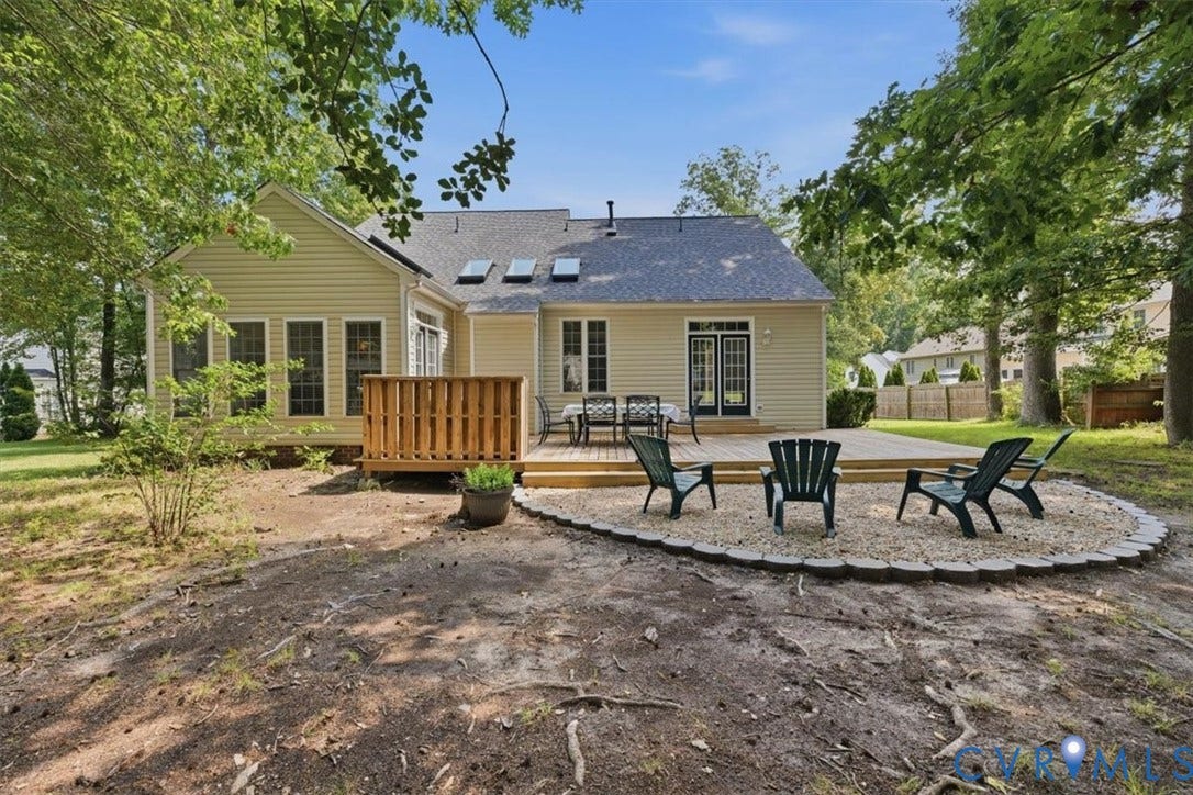 1824 Sidney Court, Glen Allen, VA 23059 Rear exterior featuring a spacious wood deck, sunroom and a gravel patio area