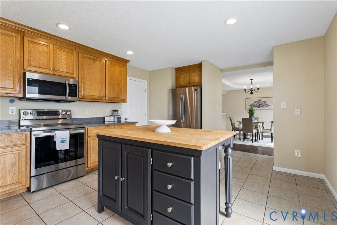 21 St Johns Drive, Hampton, VA 23666 Kitchen featuring a central island with a wood-finish countertop, stainless steel appliances, wood-finish cabinetry, recessed lighting, and tile flooring