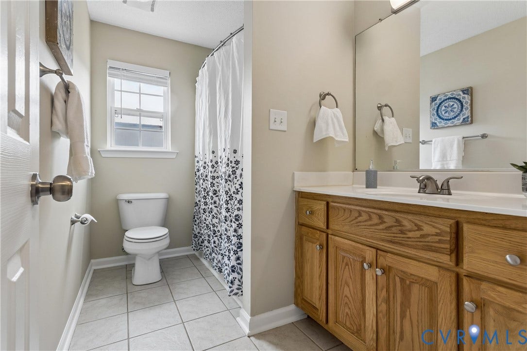 21 St Johns Drive, Hampton, VA 23666 Bathroom featuring a wood-finish vanity with a white countertop and a rectangular sink