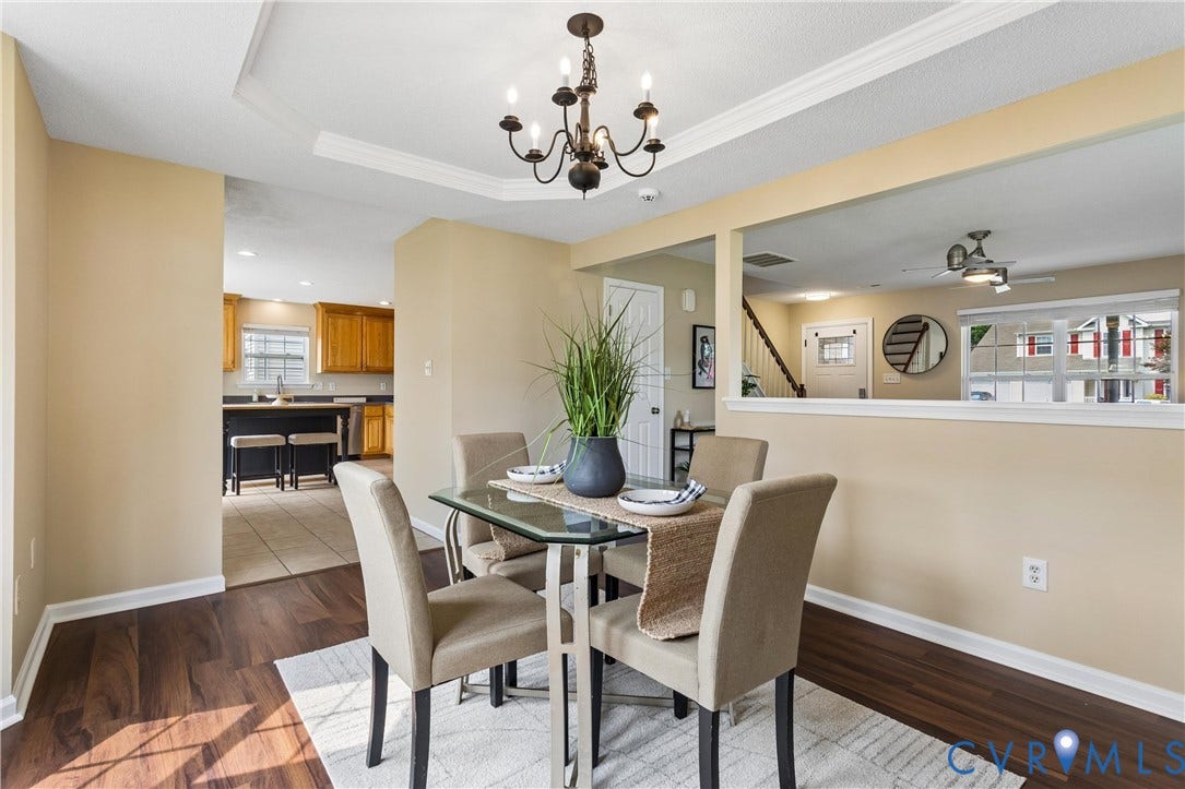 21 St Johns Drive, Hampton, VA 23666 Dining area featuring wood-finish flooring and a tray ceiling with a dark-finish chandelier