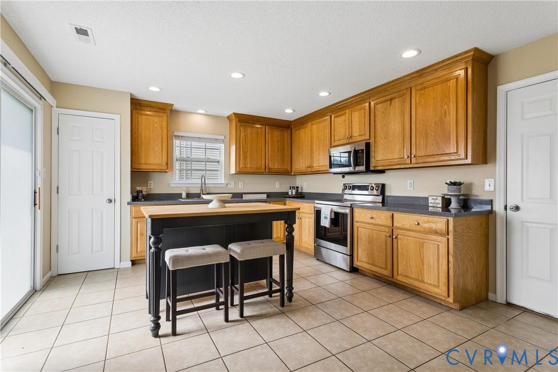 21 St Johns Drive, Hampton, VA 23666 Kitchen featuring oak cabinetry with crown molding, dark countertops, and stainless steel appliances