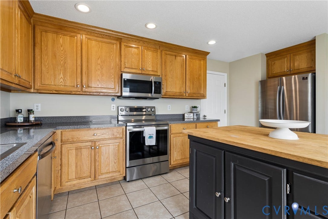 21 St Johns Drive, Hampton, VA 23666 Kitchen featuring wood cabinetry, stainless steel appliances, recessed lighting, a butcher block island, and tile flooring