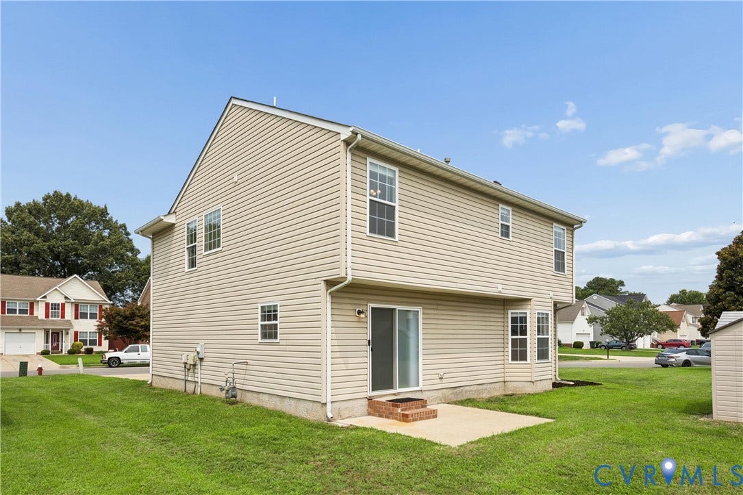 21 St Johns Drive, Hampton, VA 23666 Two-story residence featuring light-colored siding, a concrete patio, and a sliding glass door