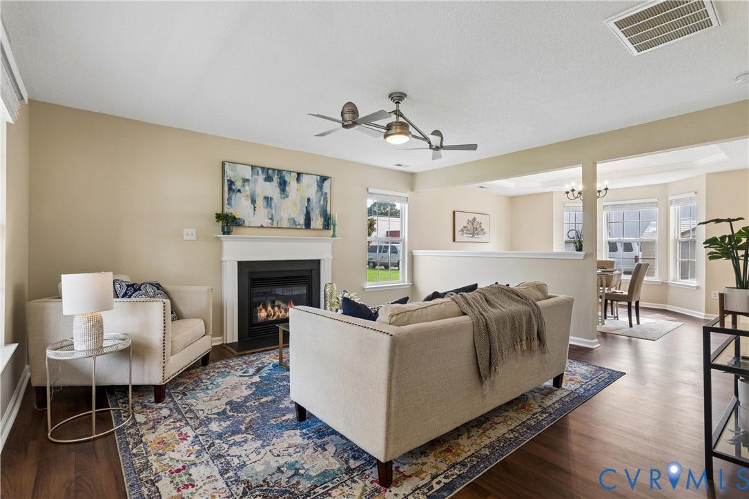 21 St Johns Drive, Hampton, VA 23666 Living room featuring wood-finish flooring, a contemporary ceiling fan, and a fireplace with a white mantel