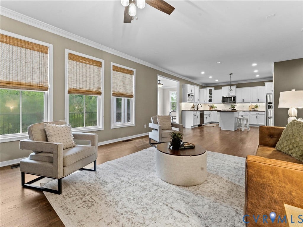 16701 Laurel Park Drive, Moseley, VA 23120 Open-concept living area featuring wood-finish flooring, a ceiling fan, and crown molding