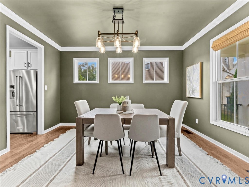 16701 Laurel Park Drive, Moseley, VA 23120 Dining area featuring wood-finish flooring, crown molding, and a contemporary chandelier
