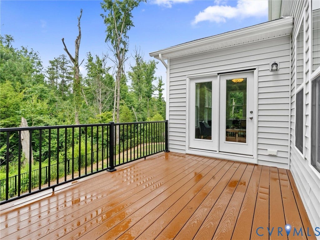 16701 Laurel Park Drive, Moseley, VA 23120 Exterior deck featuring wood-finish decking, black metal railings, and white siding