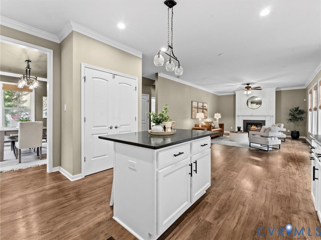 16701 Laurel Park Drive, Moseley, VA 23120 Kitchen island featuring white cabinetry with dark hardware and a contrasting dark countertop