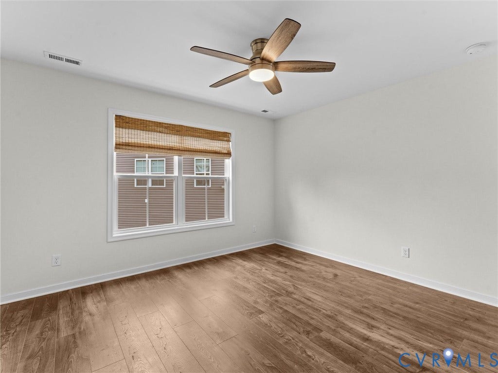 16701 Laurel Park Drive, Moseley, VA 23120 Interior room featuring wood-finish flooring, a ceiling fan with integrated lighting, and a window with a woven shade