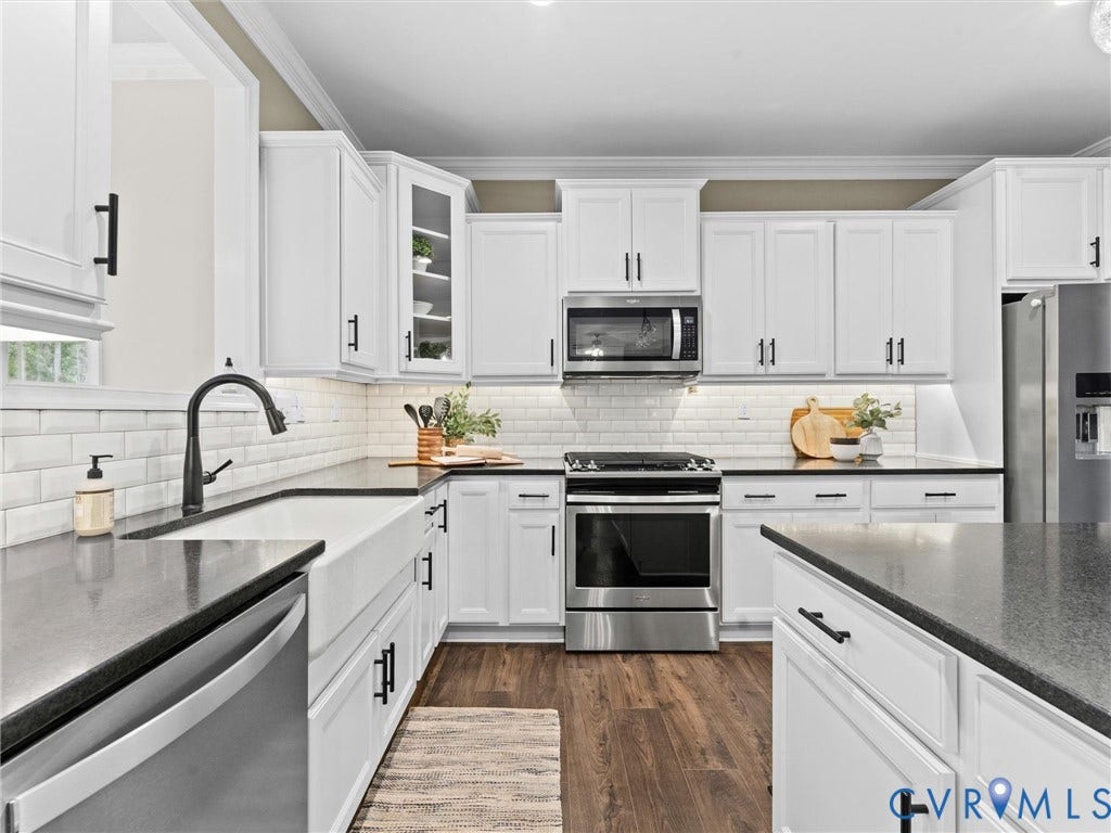 16701 Laurel Park Drive, Moseley, VA 23120 Modern kitchen featuring white cabinetry, dark countertops, and stainless steel appliances