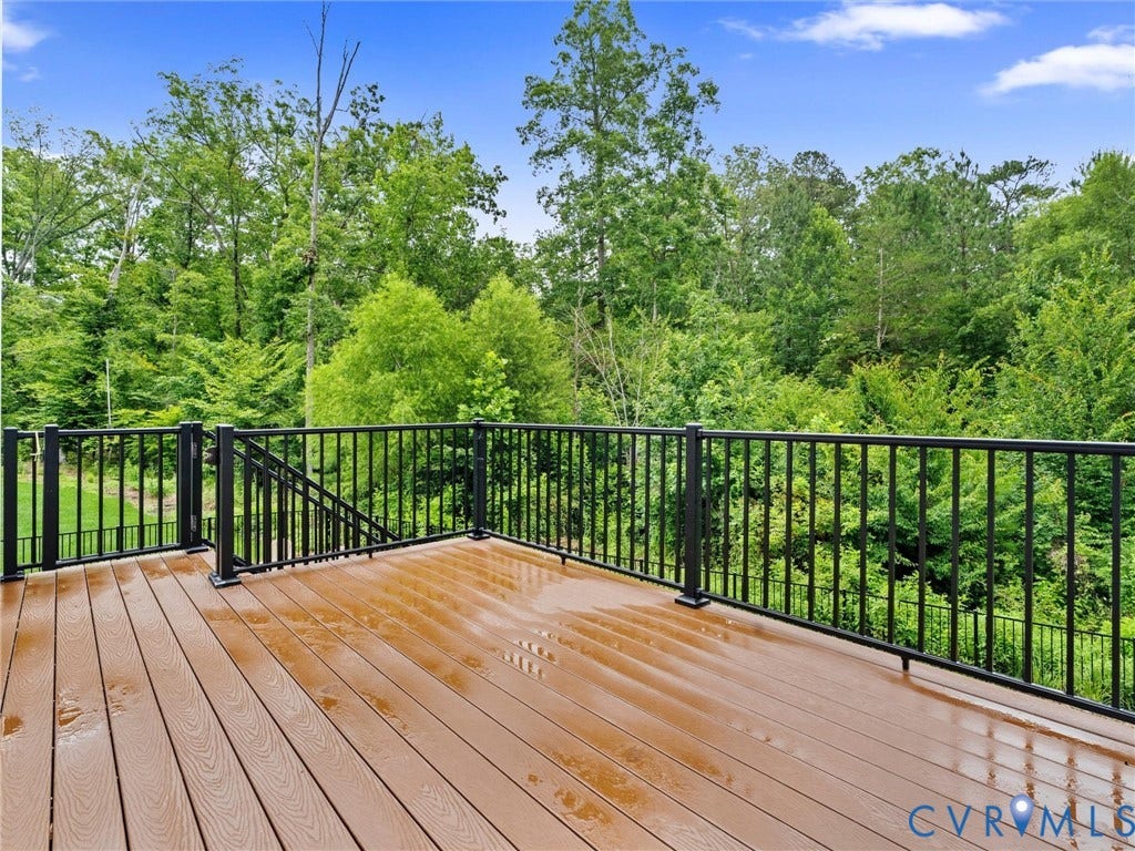 16701 Laurel Park Drive, Moseley, VA 23120 Expansive outdoor deck featuring wood-finish flooring and black metal railings