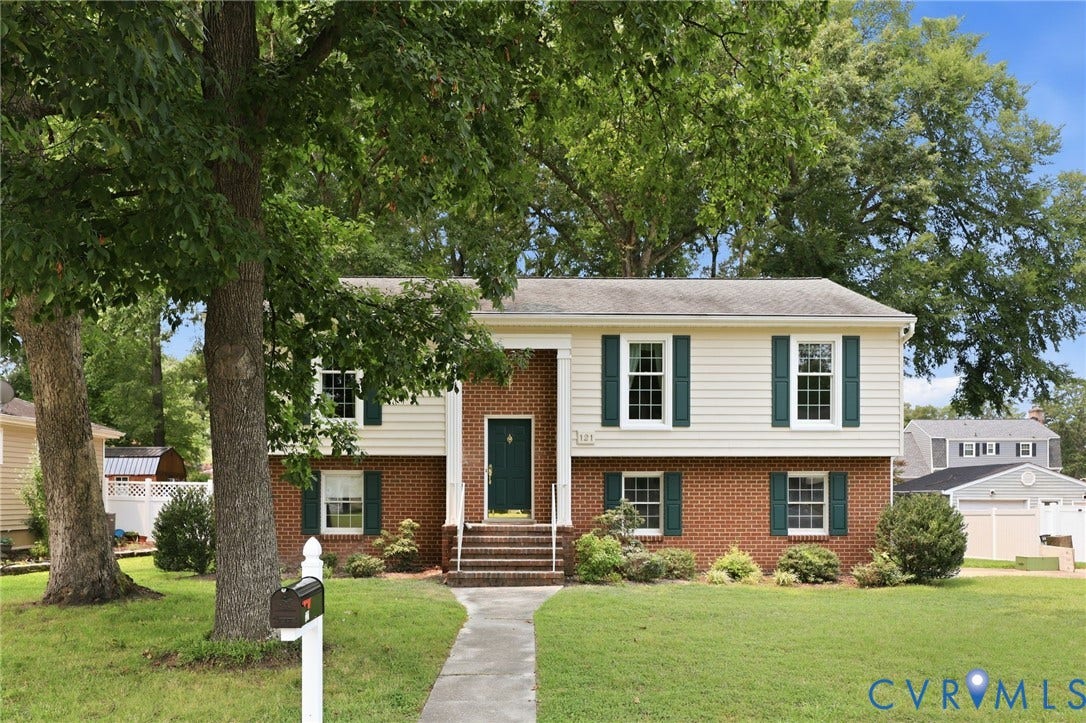 121 Huntington Road, Colonial Heights, VA 23834 Split-level residence featuring a brick and siding facade, contrasting green shutters, and a covered entryway