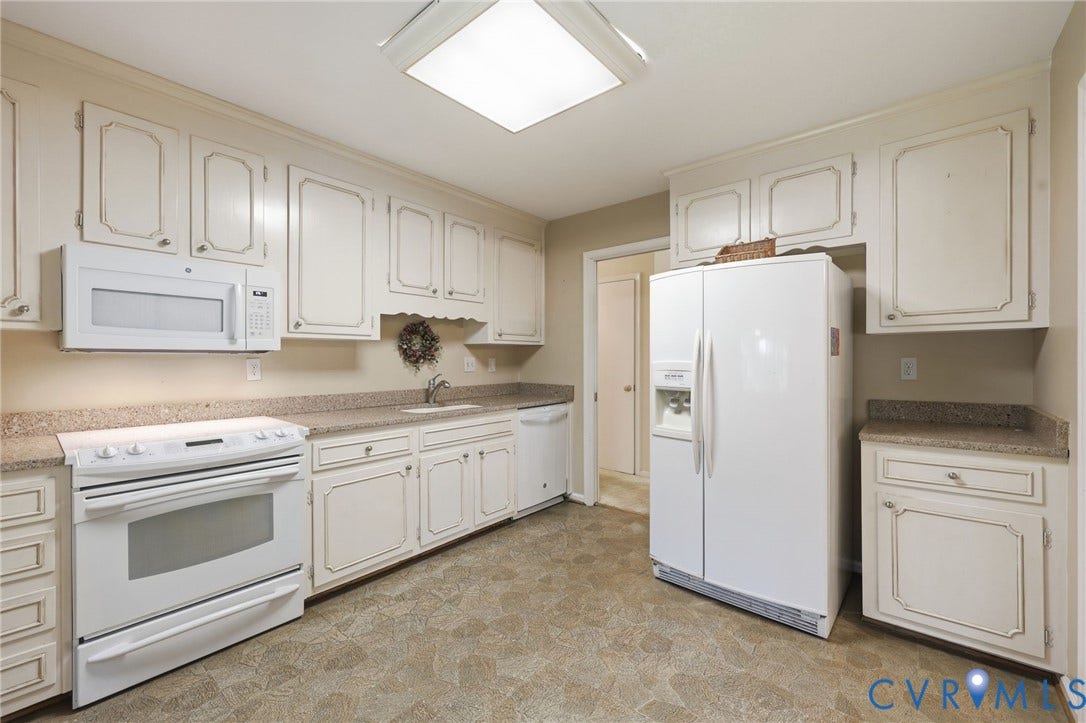 121 Huntington Road, Colonial Heights, VA 23834 Kitchen featuring white cabinetry with decorative trim, light-toned countertops, and vinyl flooring