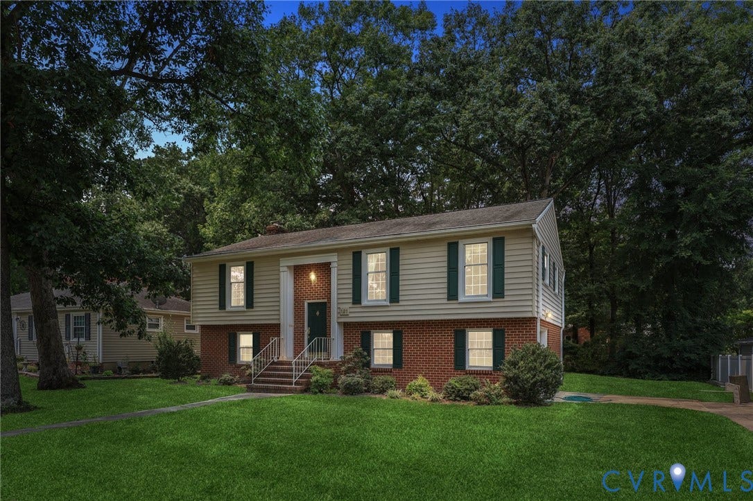121 Huntington Road, Colonial Heights, VA 23834 Split-level residence featuring a brick and siding exterior, green shutters, and a prominent front entrance with columns
